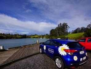 car by river